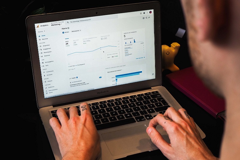 User looks at laptop as Google updates its analytics version to GA4